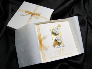 Wedding card with two white roses and gold ribbon