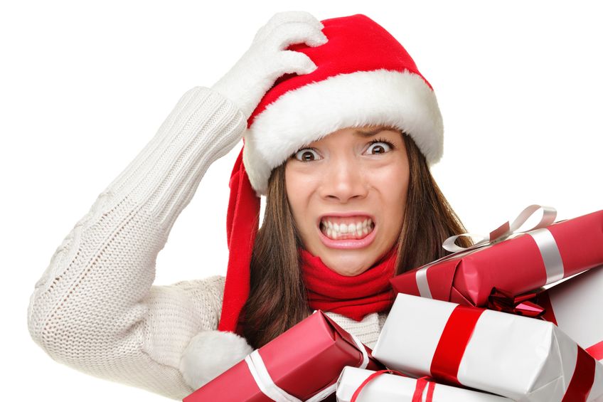 Female stressing about christmas, holding christmas gifts