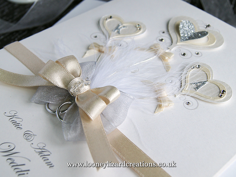 ivory and silver luxury wedding card with three heart shaped balloons