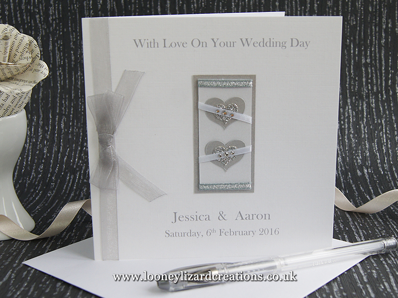 Wedding card featuring two hearts in silver and white