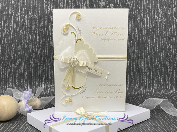 Luxury boxed new baby card featuring baby feet, gold foil, mixed ribbons and diamante heart