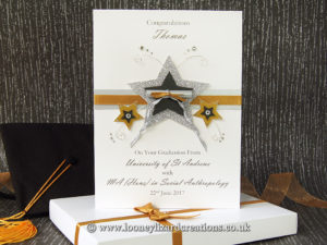 Graduation card featuring pearl and glitter stars, wire, ribbon and crystals with rolled diploma