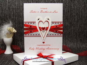featuring entwined heart with crystals, ribbon and glitter