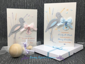 Picture of two greeting cards, featuring a stork with in both pink and blue