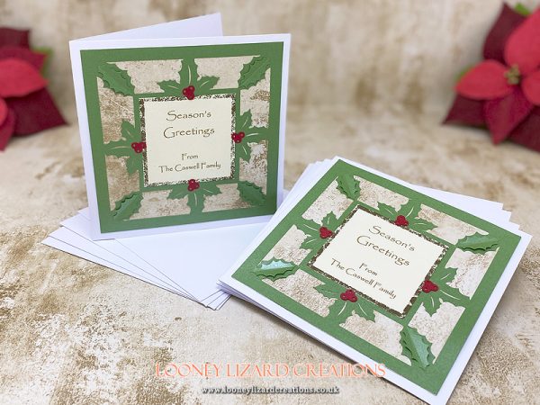 christmas card with a holly leaf frame in green, cream, gold and red