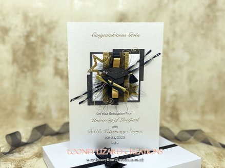 Accolade: In black and gold with gradution cap and certificate