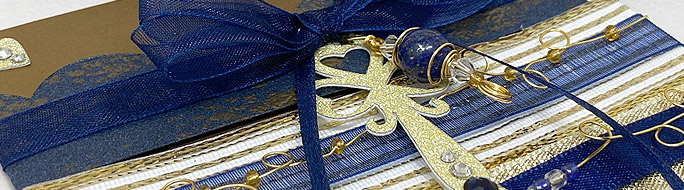 close up of card with gold glittery key and lapis bead