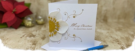 Christmas card with white and gold paper hellebore flower